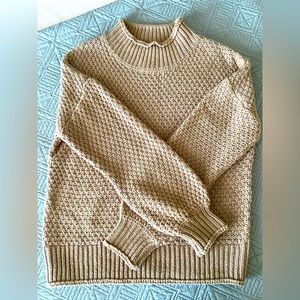Adorable warm knit sweater! Bell- like arms and tapered wrists and collar.